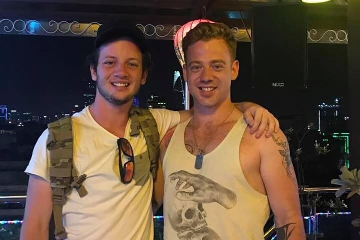 two men are standing next to each other