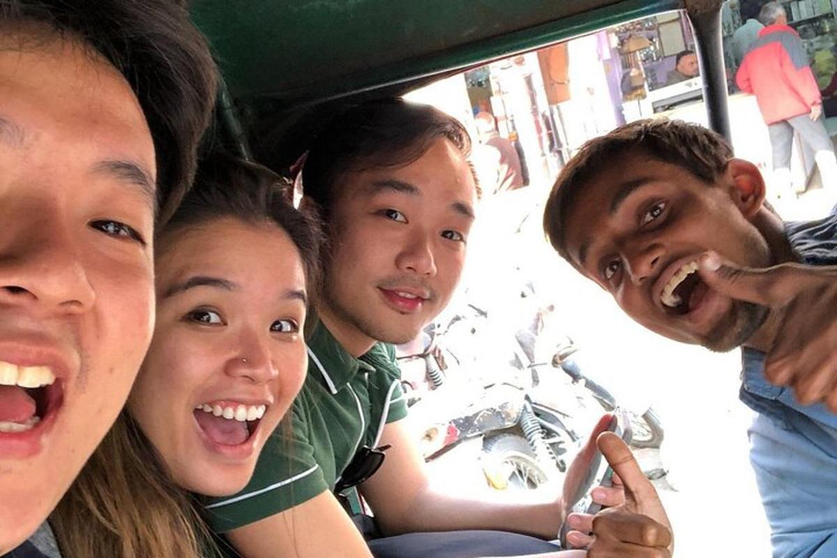 a group of people sitting in the back of a vehicle