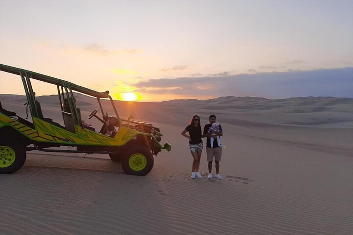 two people standing in the desert next to a bus
