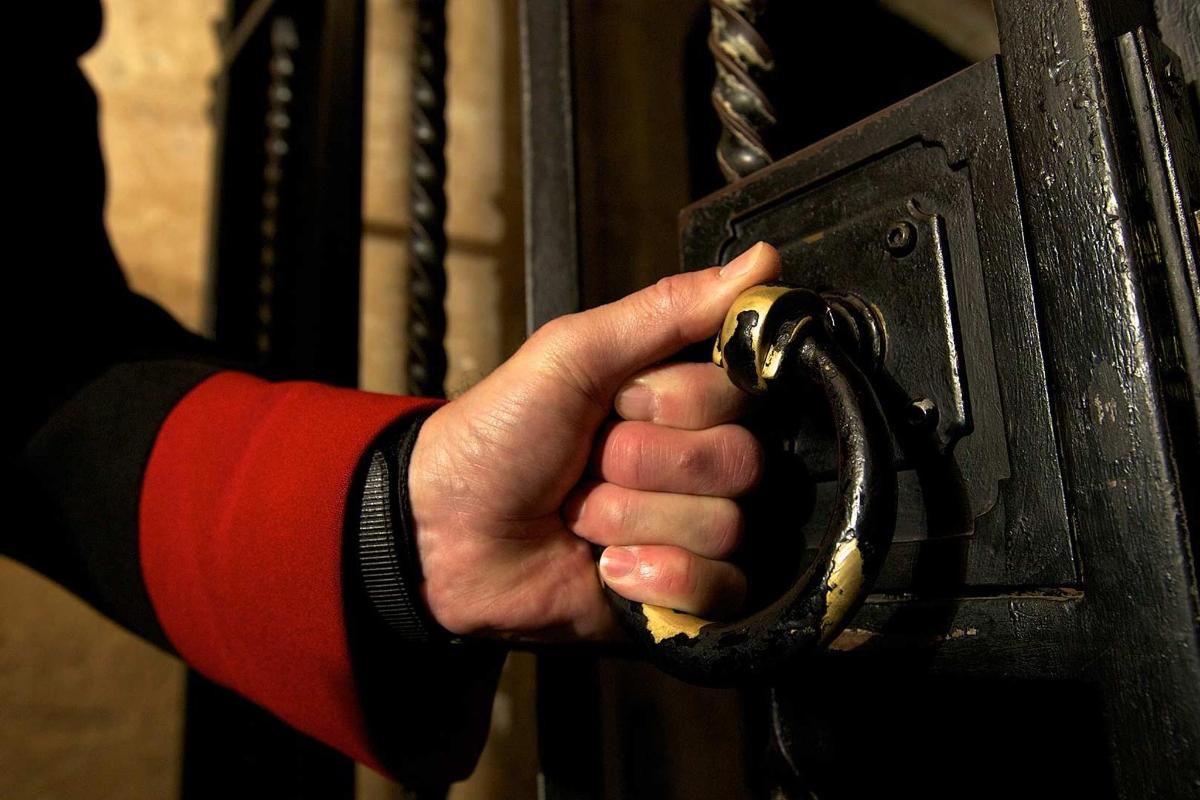 a hand is unlocking a door with a lock