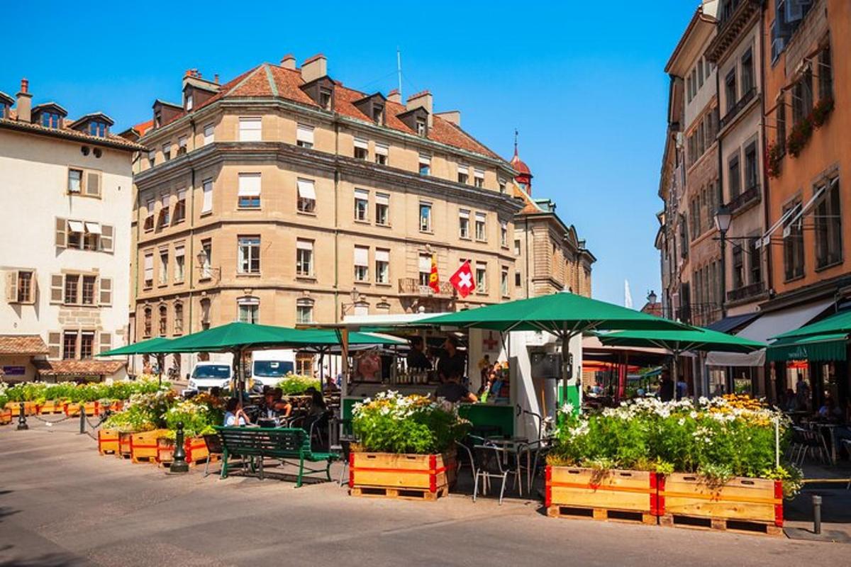 a group of tables with green umbrellas in front of a building