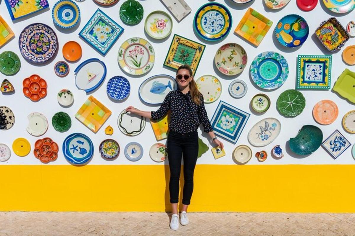 a woman standing in front of a wall of plates