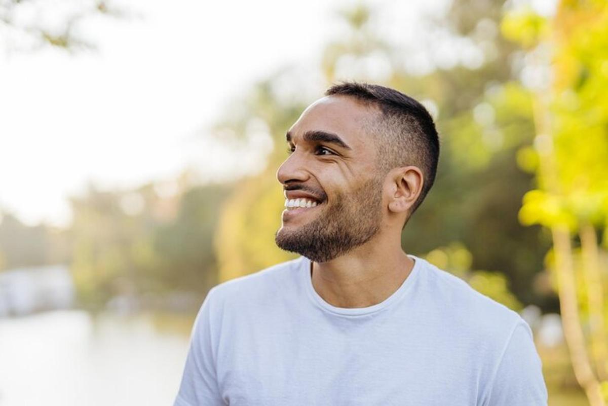 a man in a white shirt is smiling