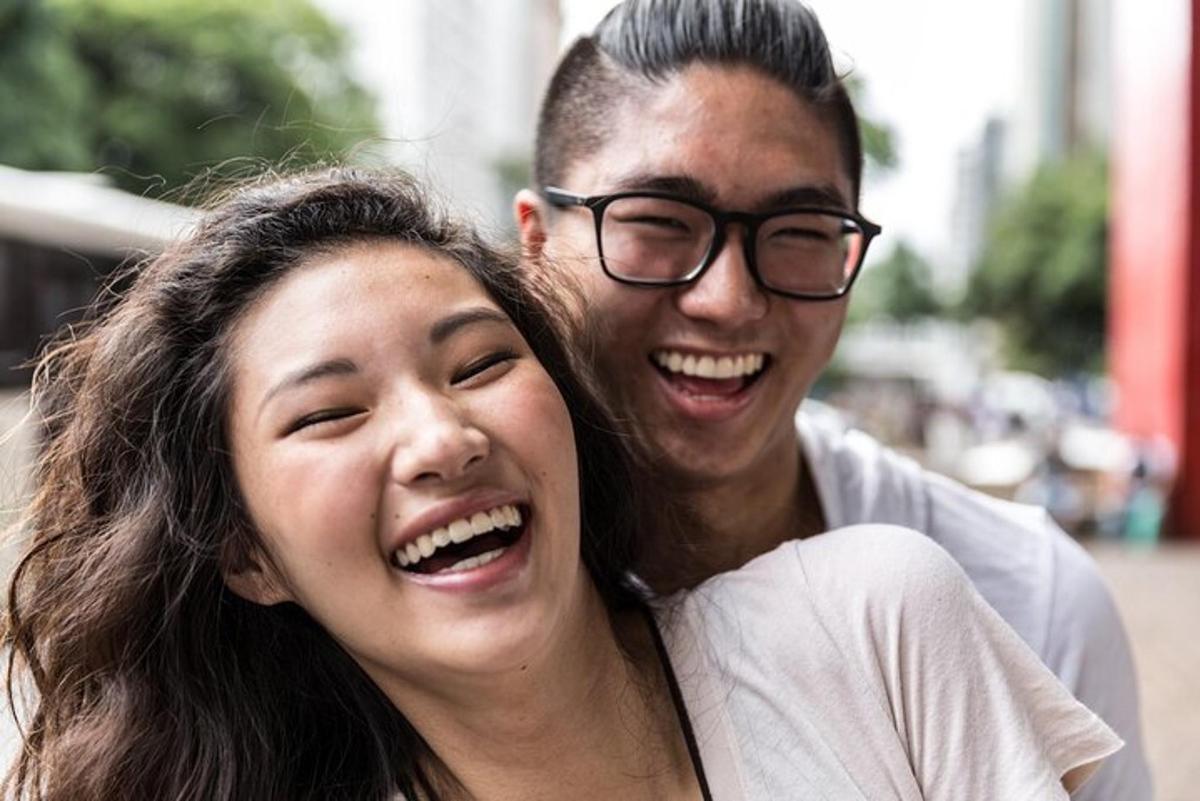 a man and a woman smiling and hugging each other