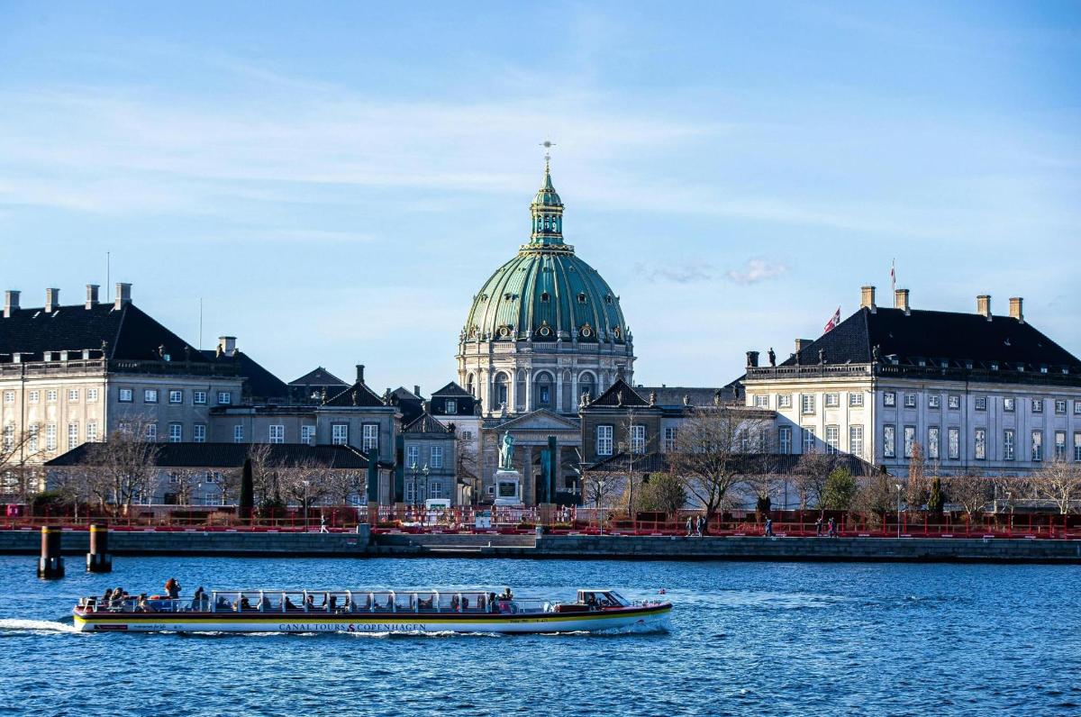 a boat in the water in front of a city