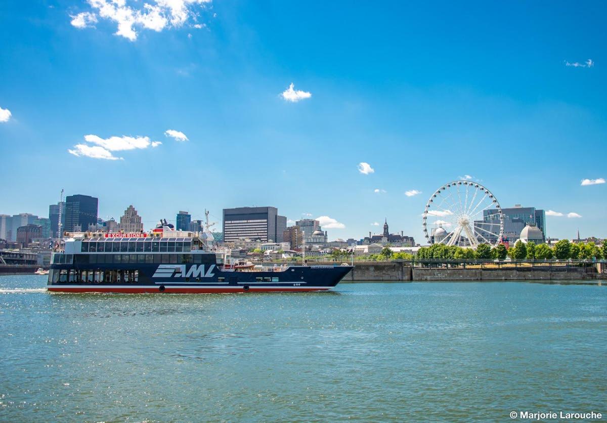 a cruise ship in the water with a city in the background