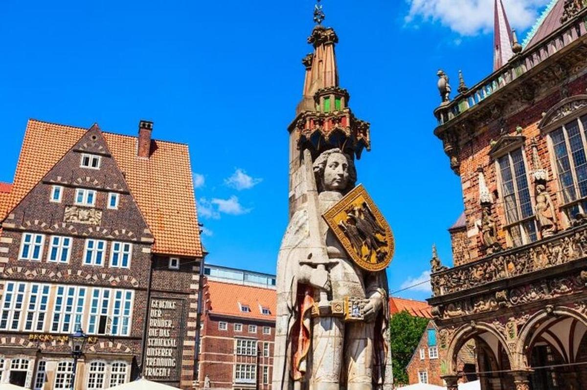 a statue in front of a building with a tower