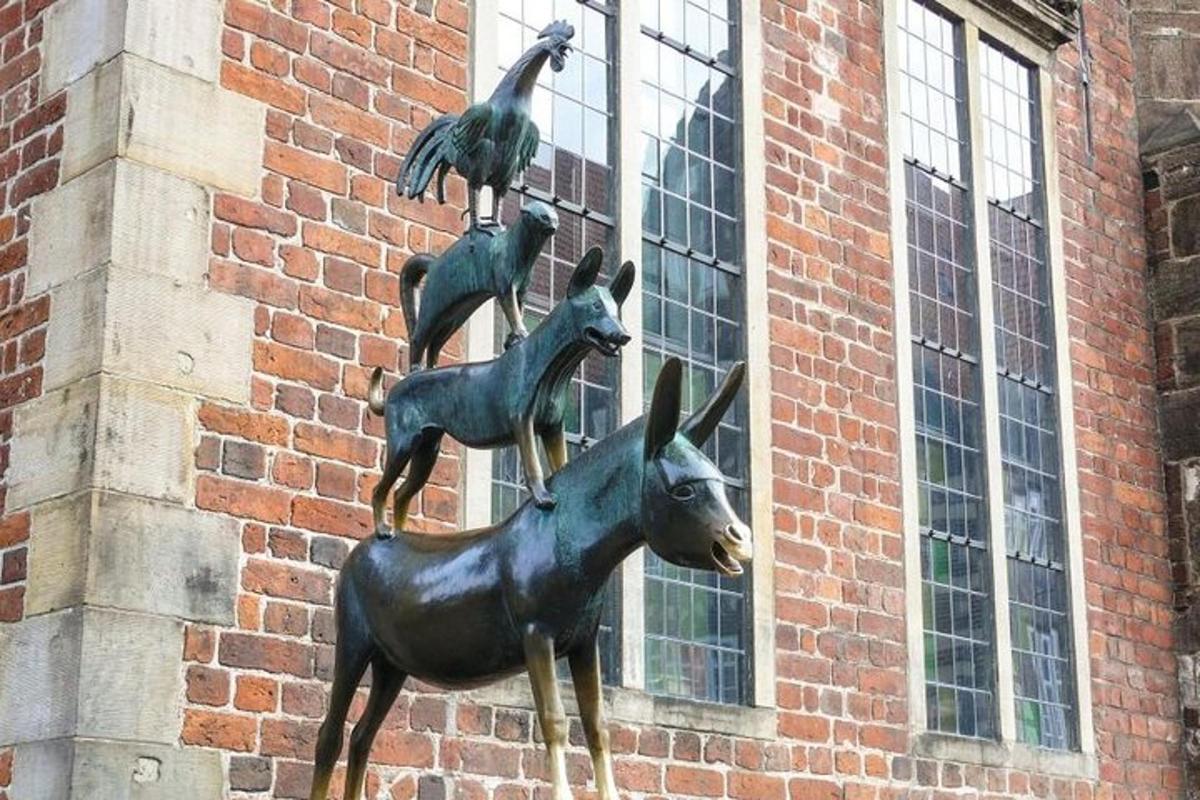 a statue of three deer and a bird on a building