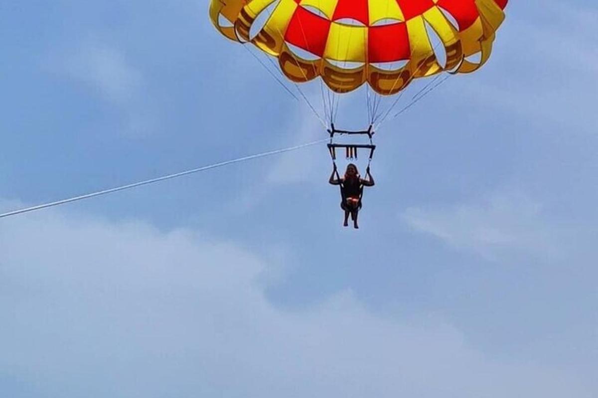 muž letící na padáku na obloze