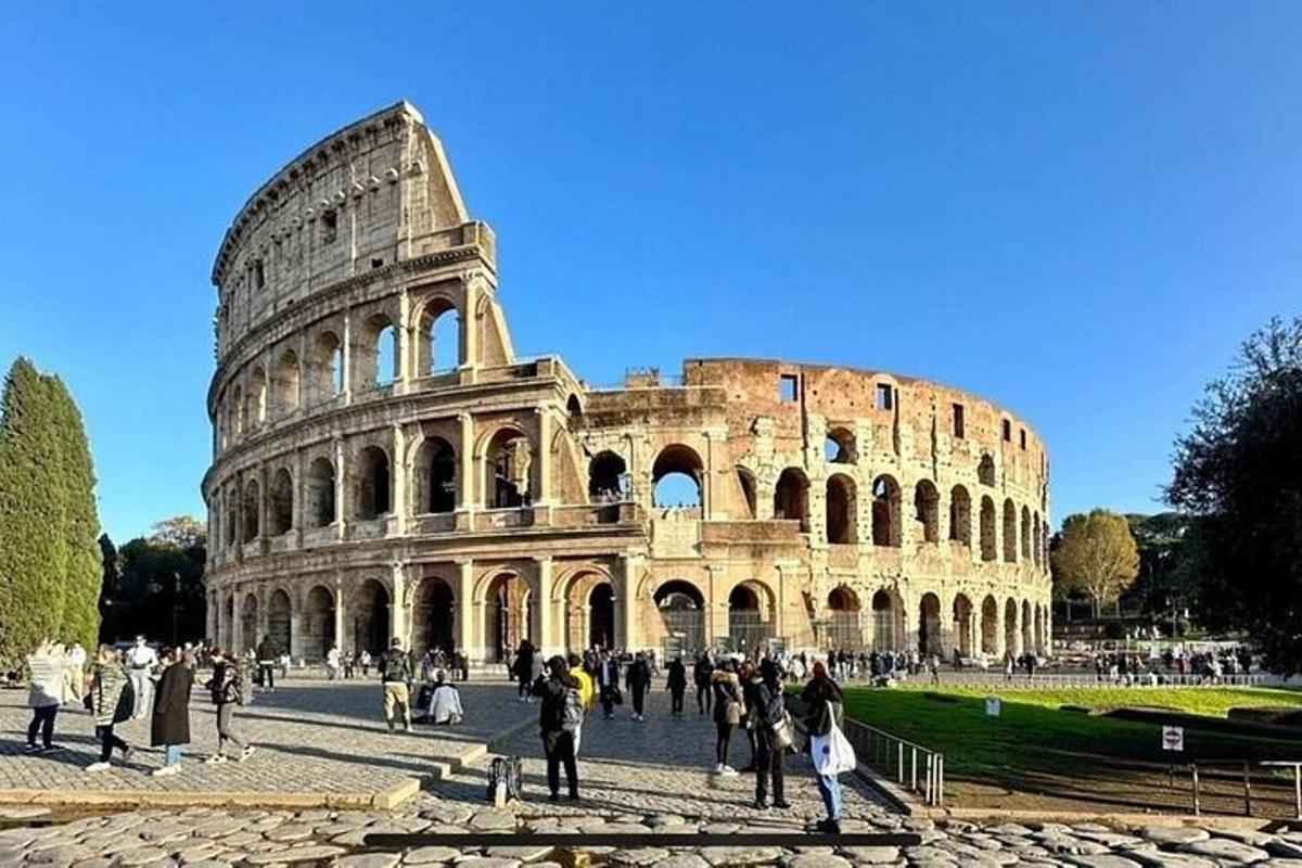 a group of people standing in front of the coliseum