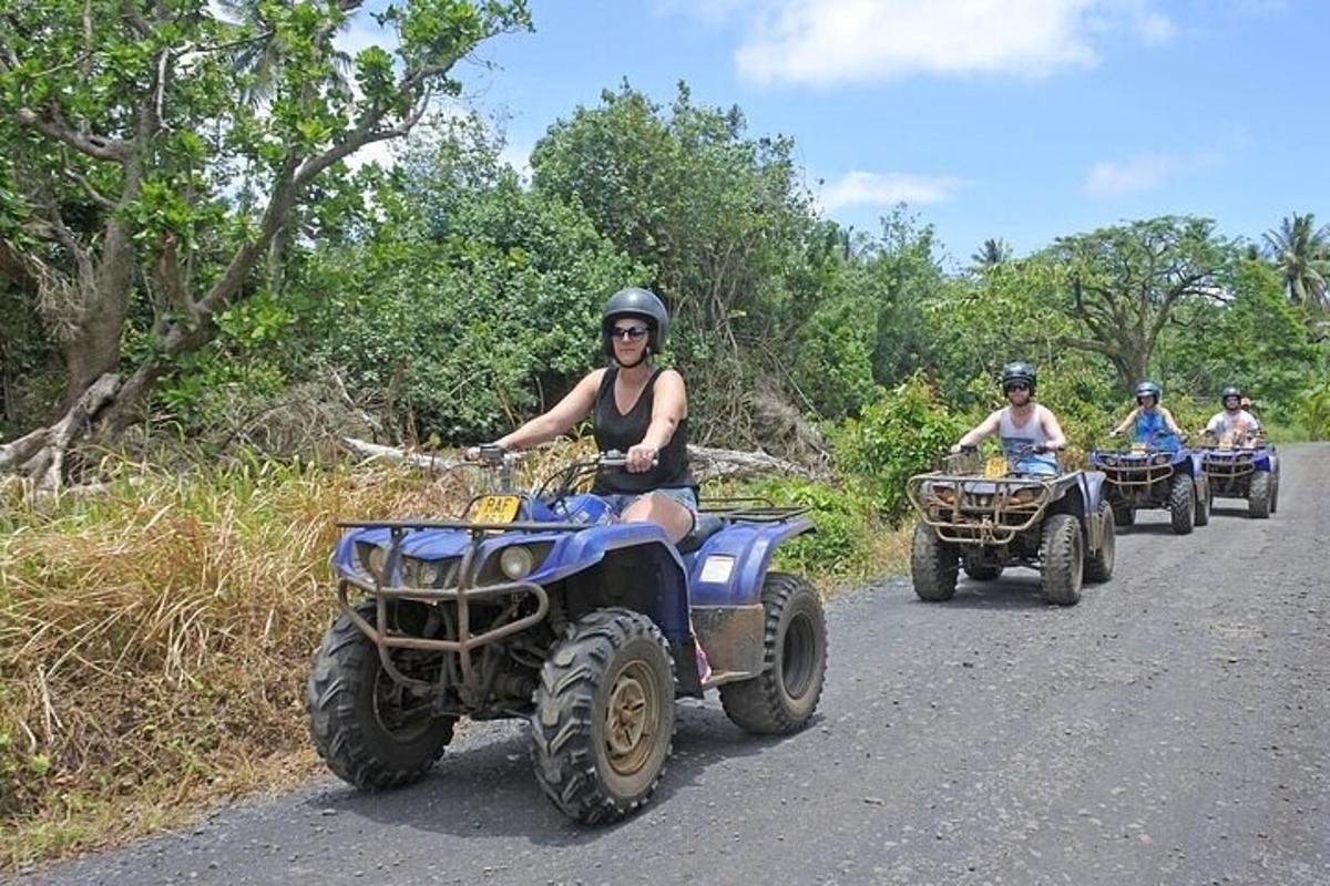 a group of people riding atvs down a road