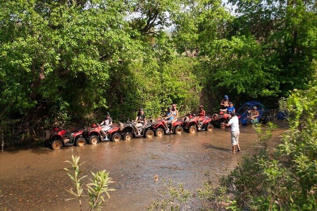 a group of people on atvs crossing a river