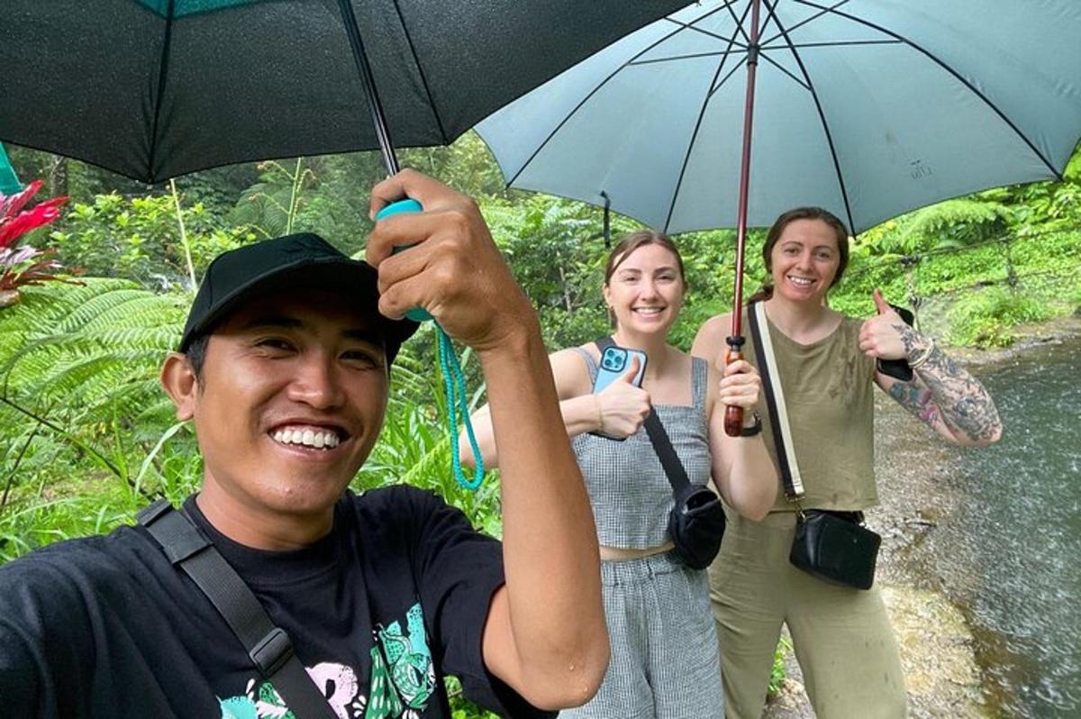 a group of three people holding an umbrella