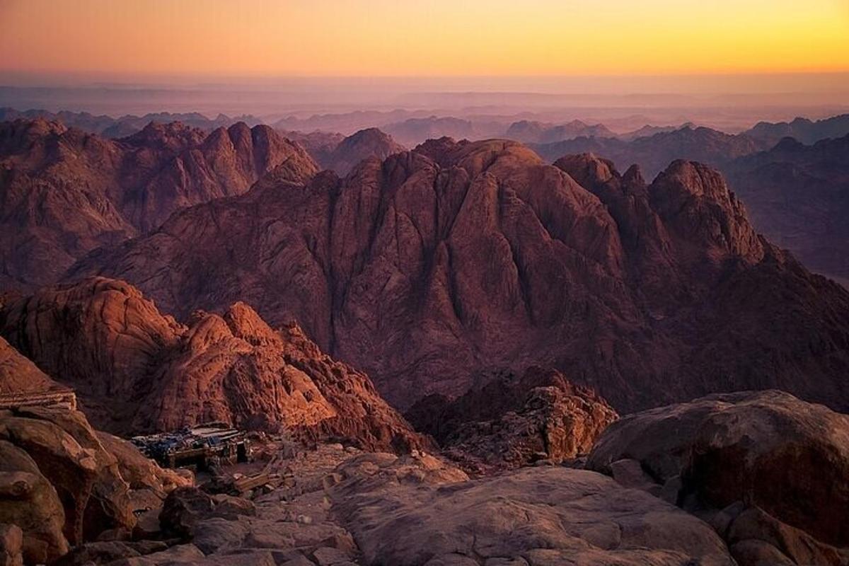 a view from the top of a mountain at sunset