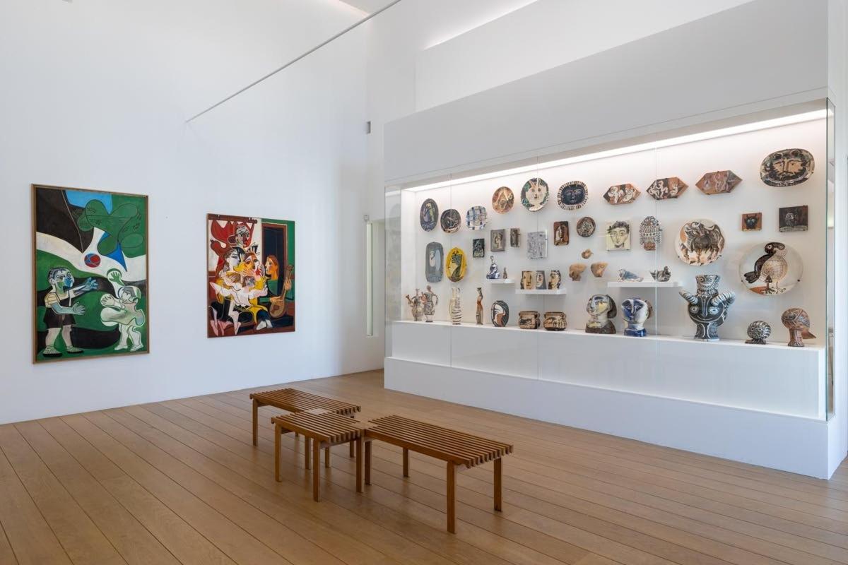 a room with two tables and plates on a wall