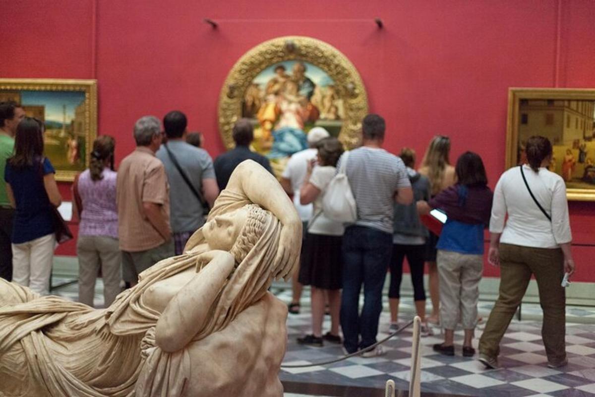 a crowd of people looking at a painting in a museum