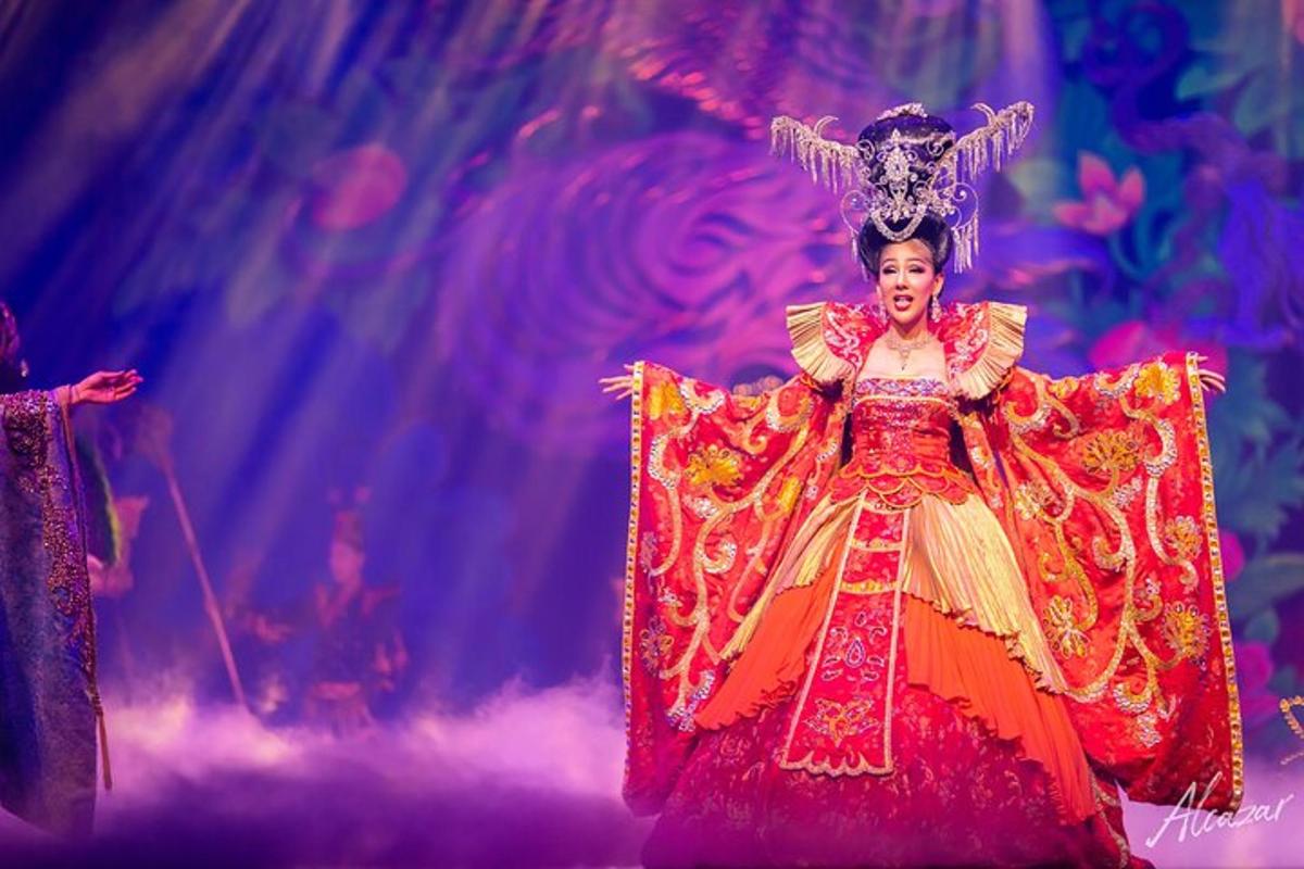 a woman in a colorful dress on a stage