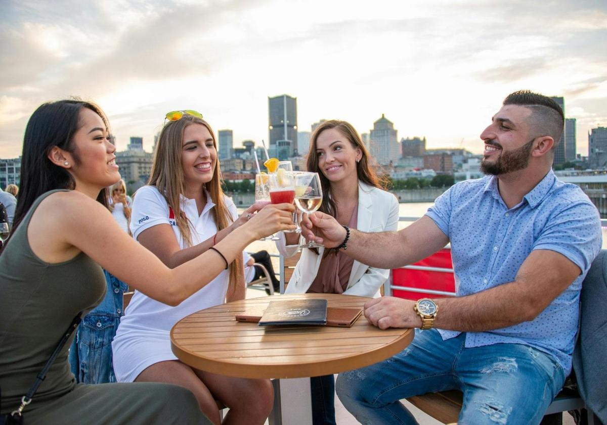 a group of people sitting around a table drinking champagne