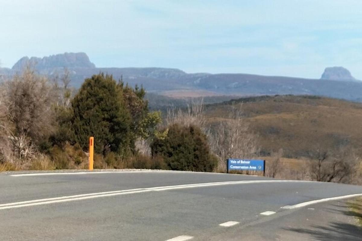 an empty road with a sign on the side of it