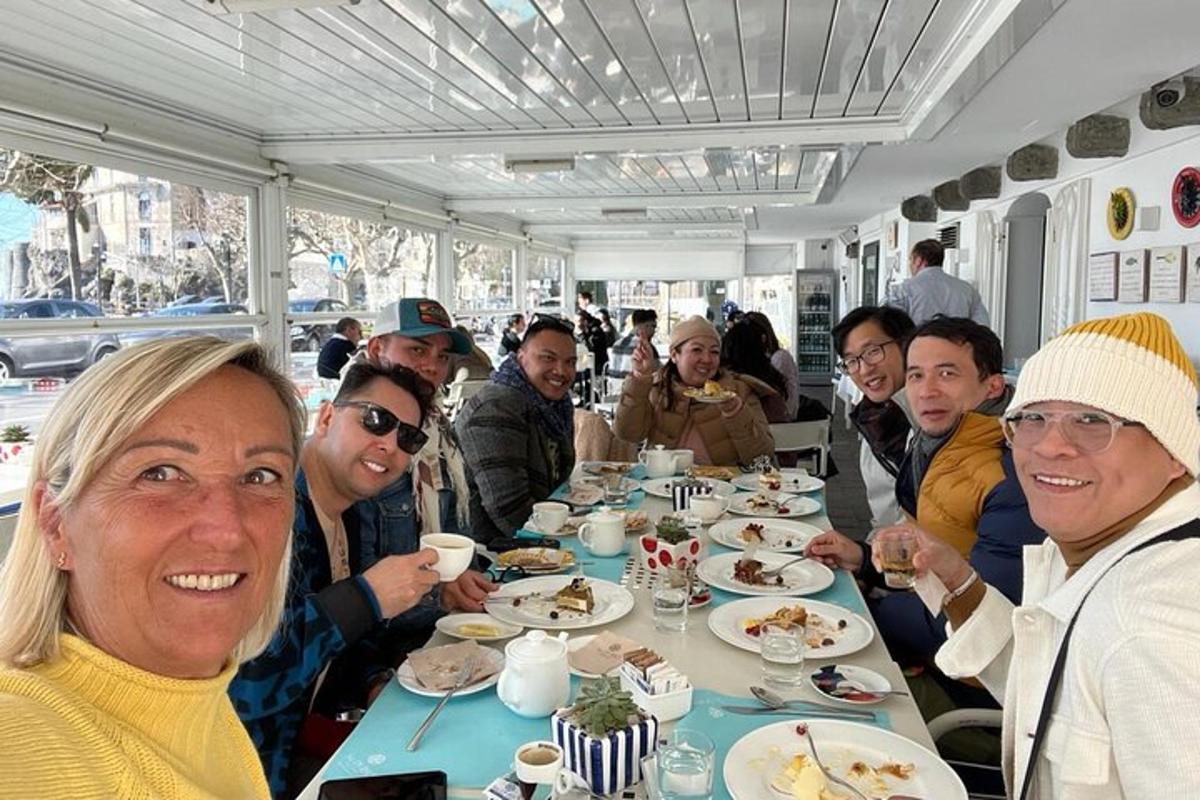 a group of people sitting around a table eating food