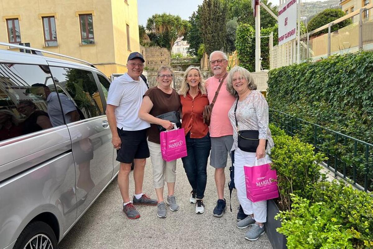 a group of people standing in front of a car