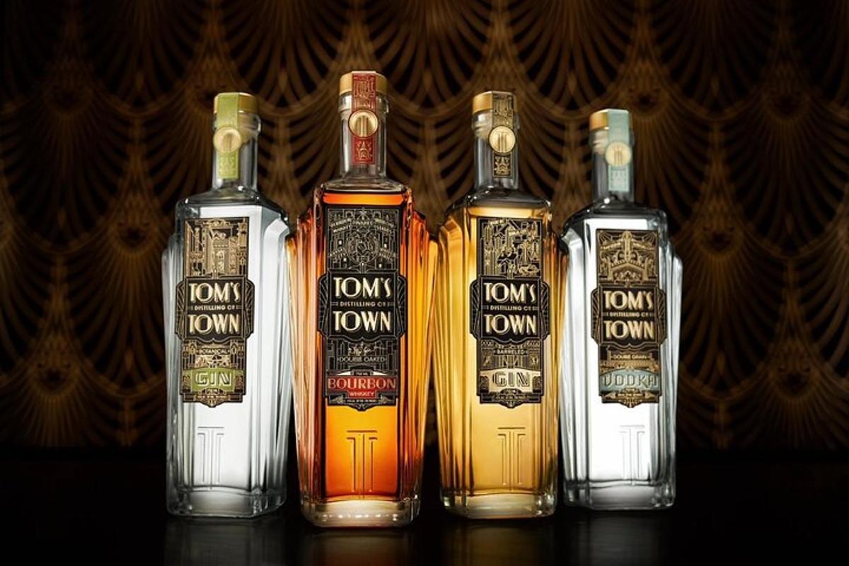 a group of four bottles of whisky on a table