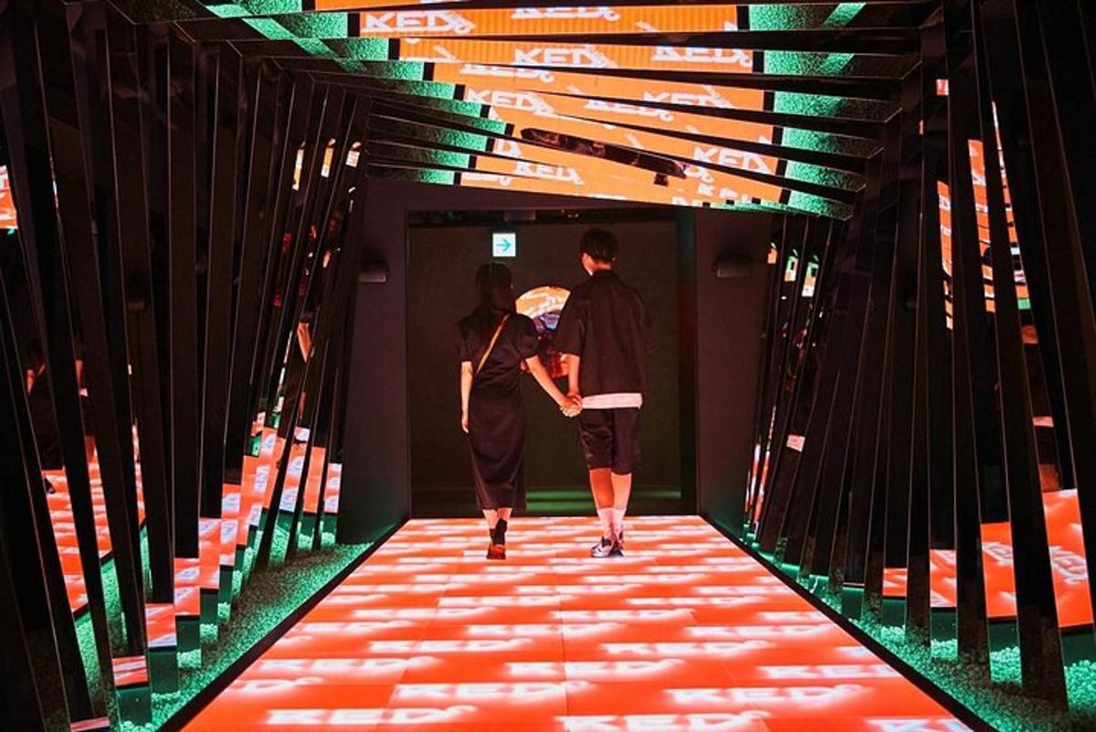 two people walking down a red carpeted hallway