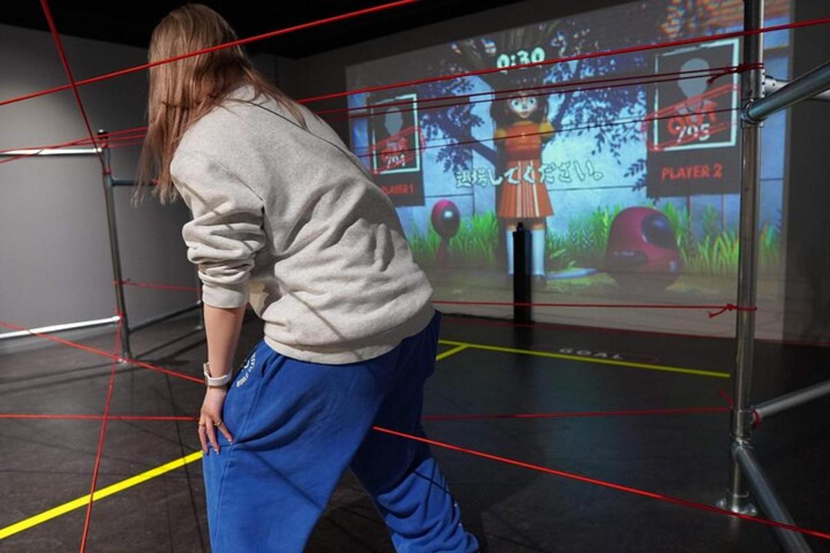 a woman standing in front of a video game