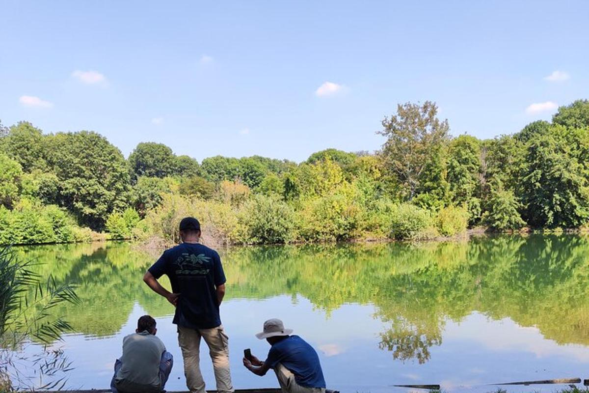 a group of three men standing in a body of water