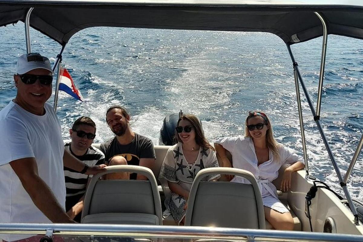 a group of people sitting on a boat in the water