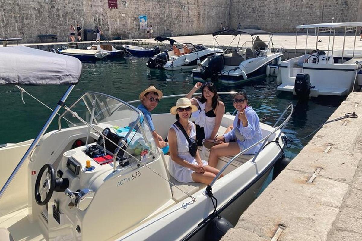 a group of people sitting on a boat in the water