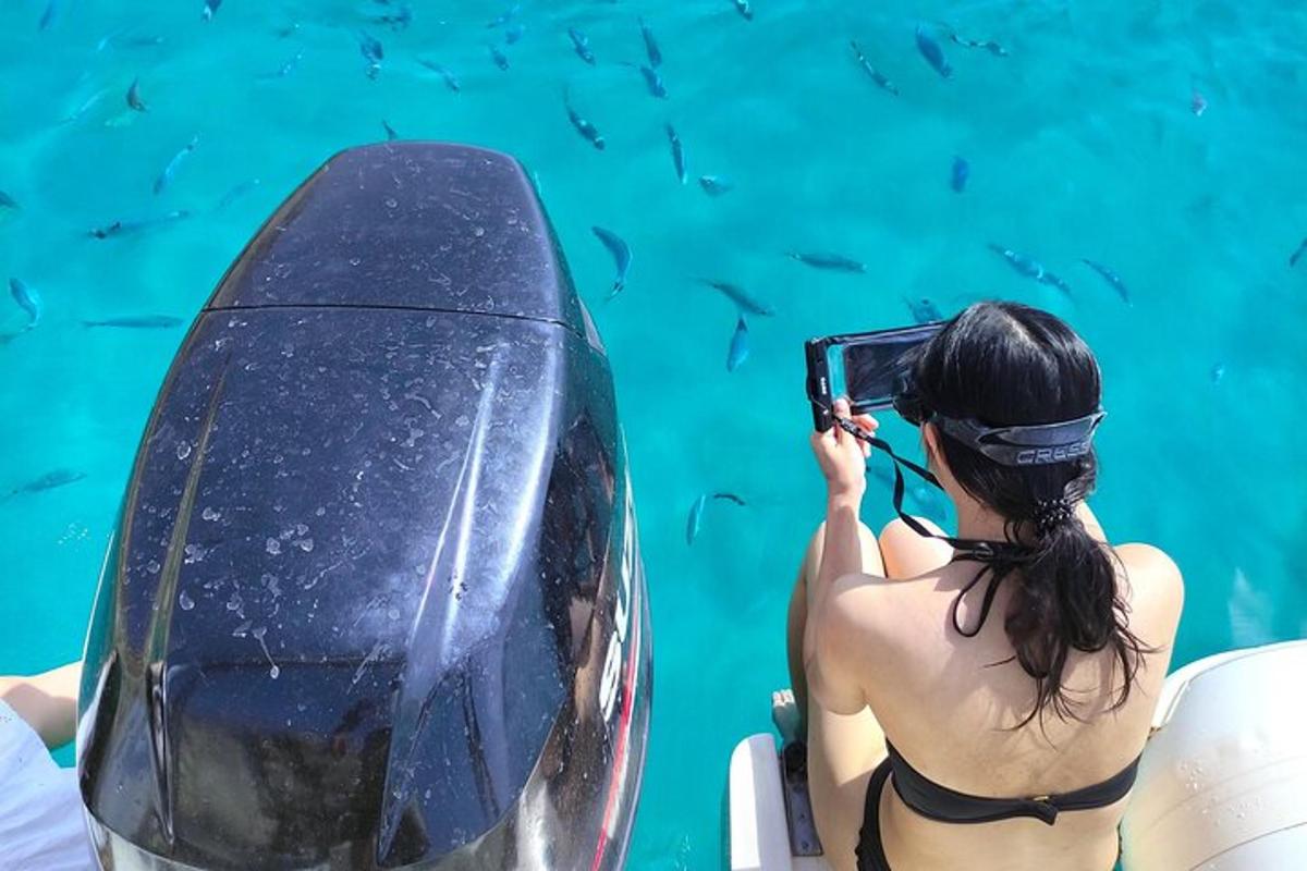 a woman in a bikini taking a picture of a boat