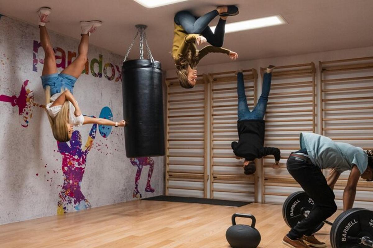 a group of people in a gym jumping in a punching bag