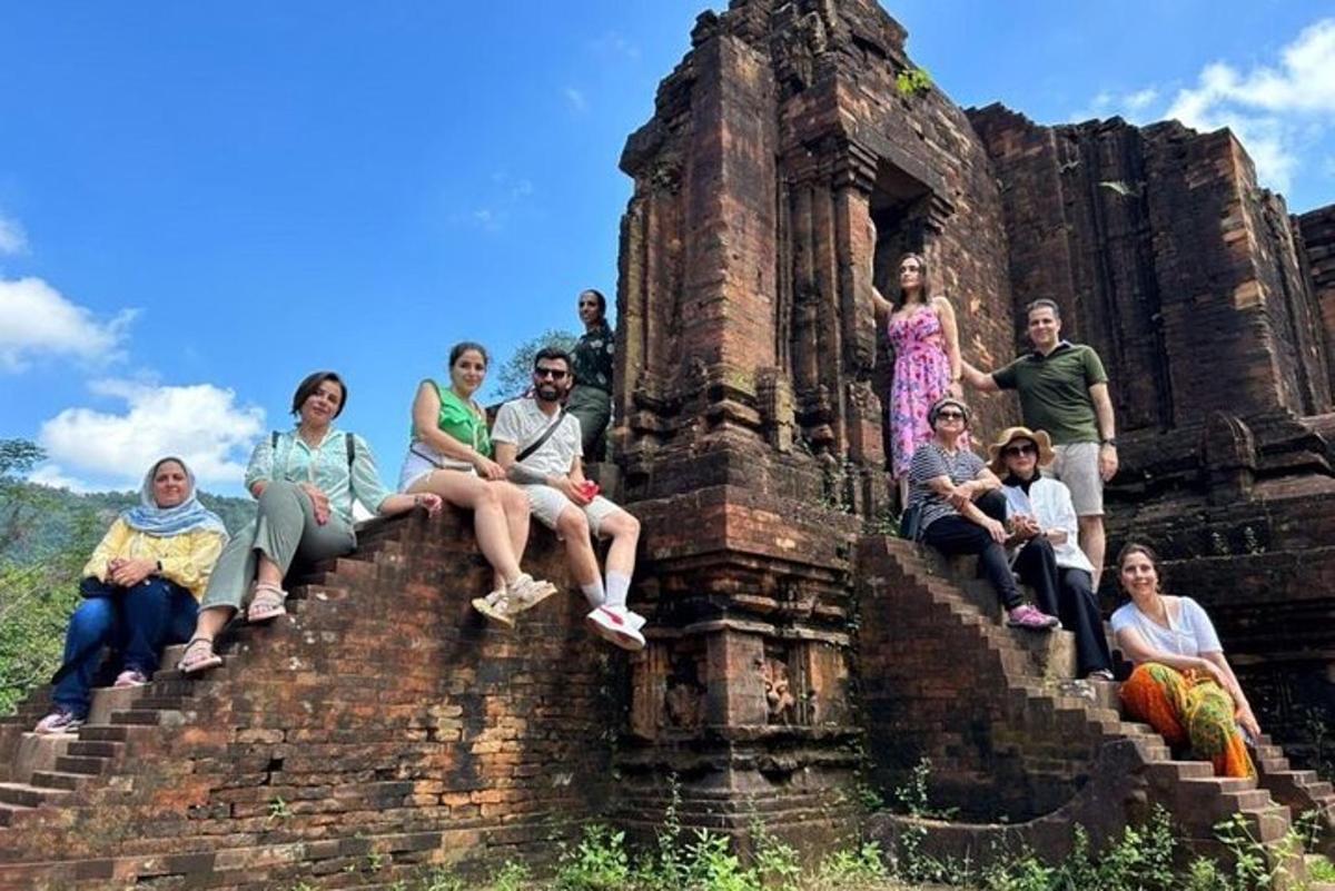 a group of people sitting on the steps of an old building