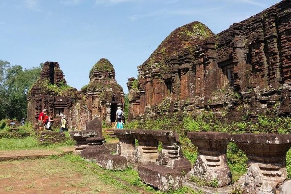 a group of people walking around an ancient ruins