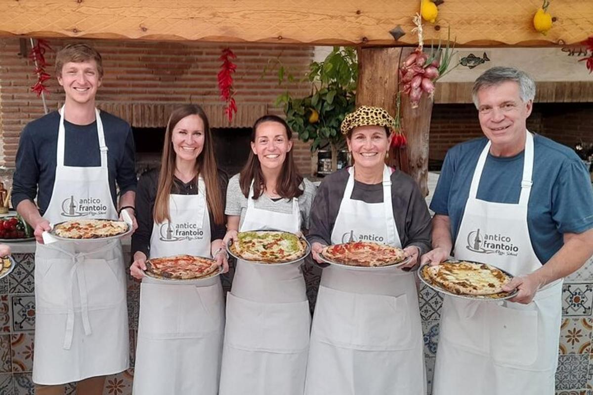 a group of people holding plates of pizzas