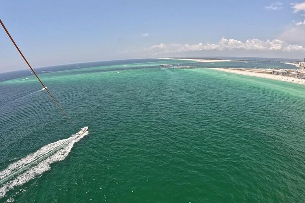 an aerial view of the ocean with a boat in the water