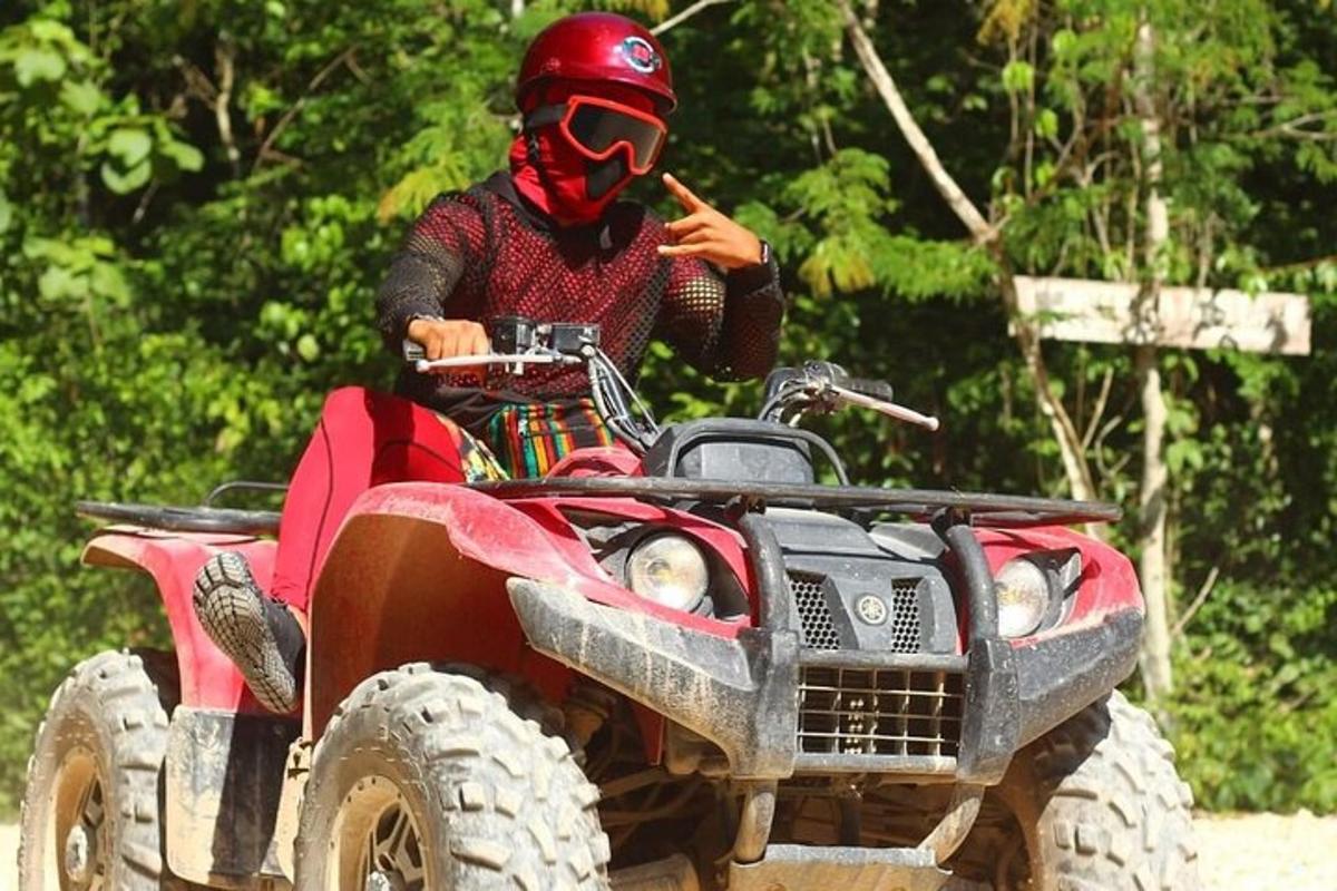 a man in a red helmet on a red atv