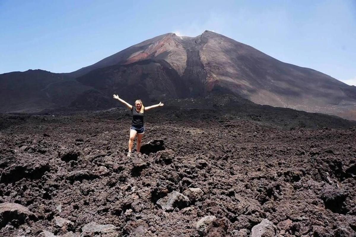 a woman standing in front of a mountain