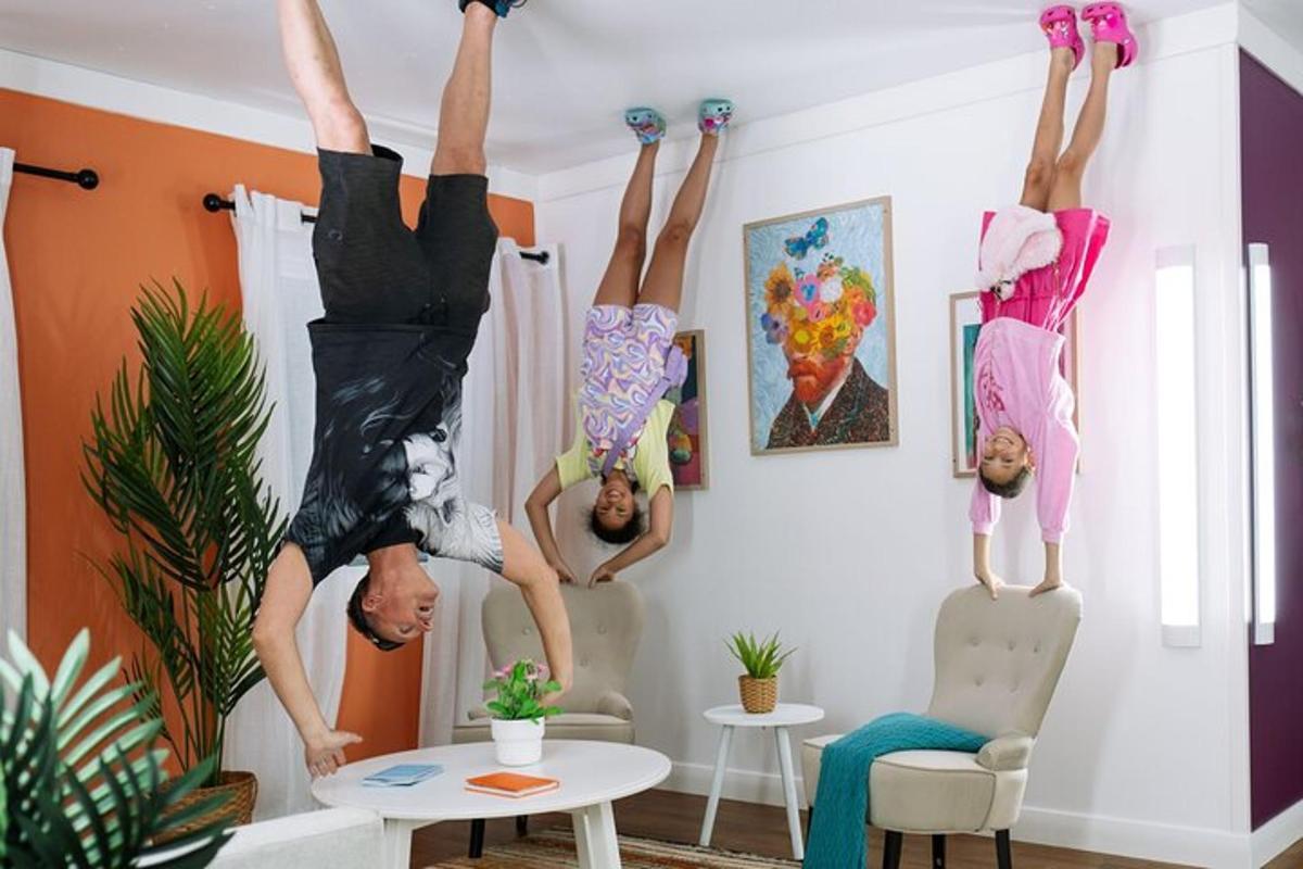 a group of people doing tricks in a living room