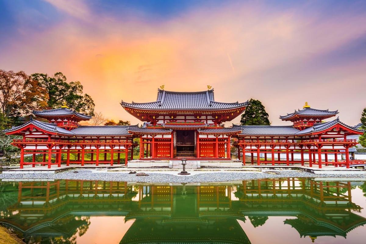 a temple with a pond in front of it