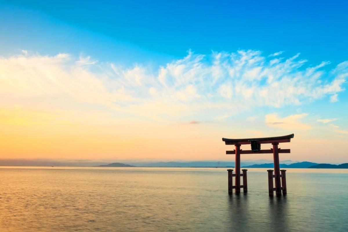 Brána torii ve vodě při západu slunce