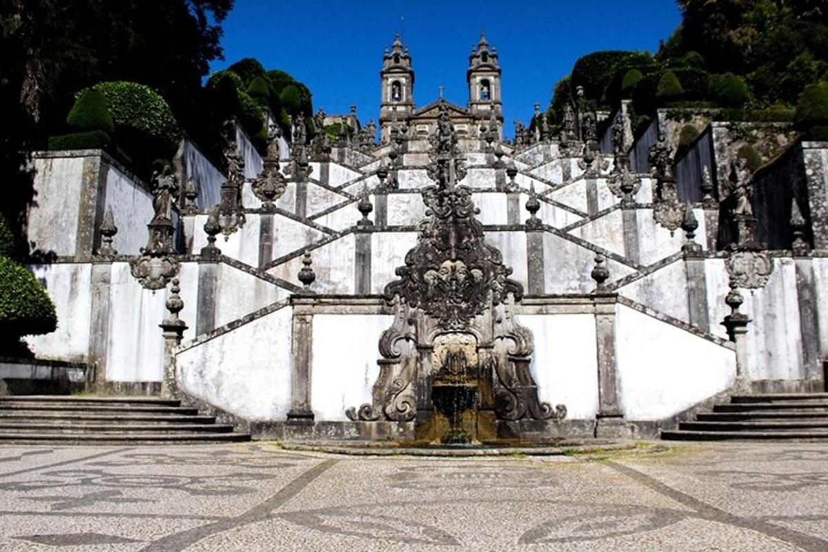 a fountain in front of a white building with stairs