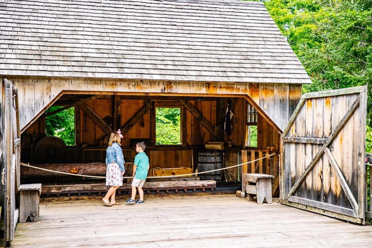 two people standing inside of a wooden barn