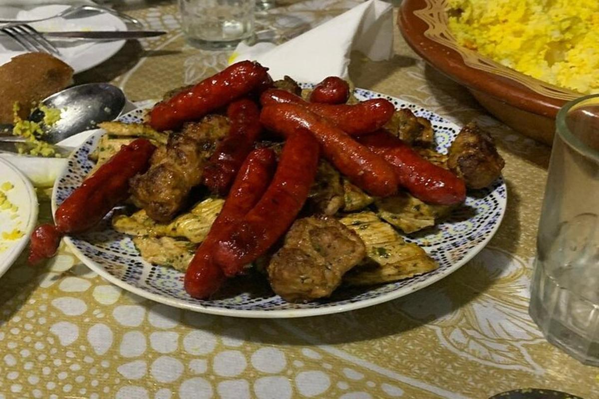 a plate of food with sausage and other foods on a table