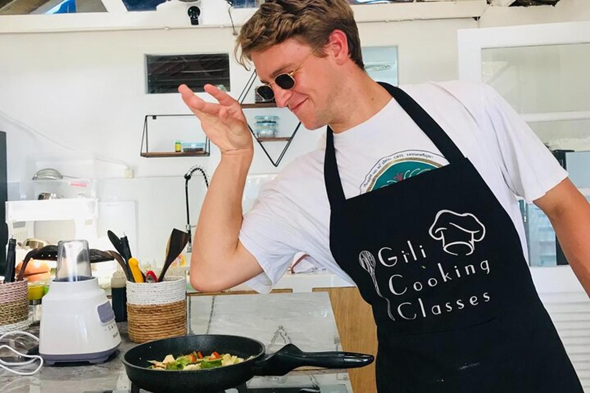 a man standing in a kitchen preparing food