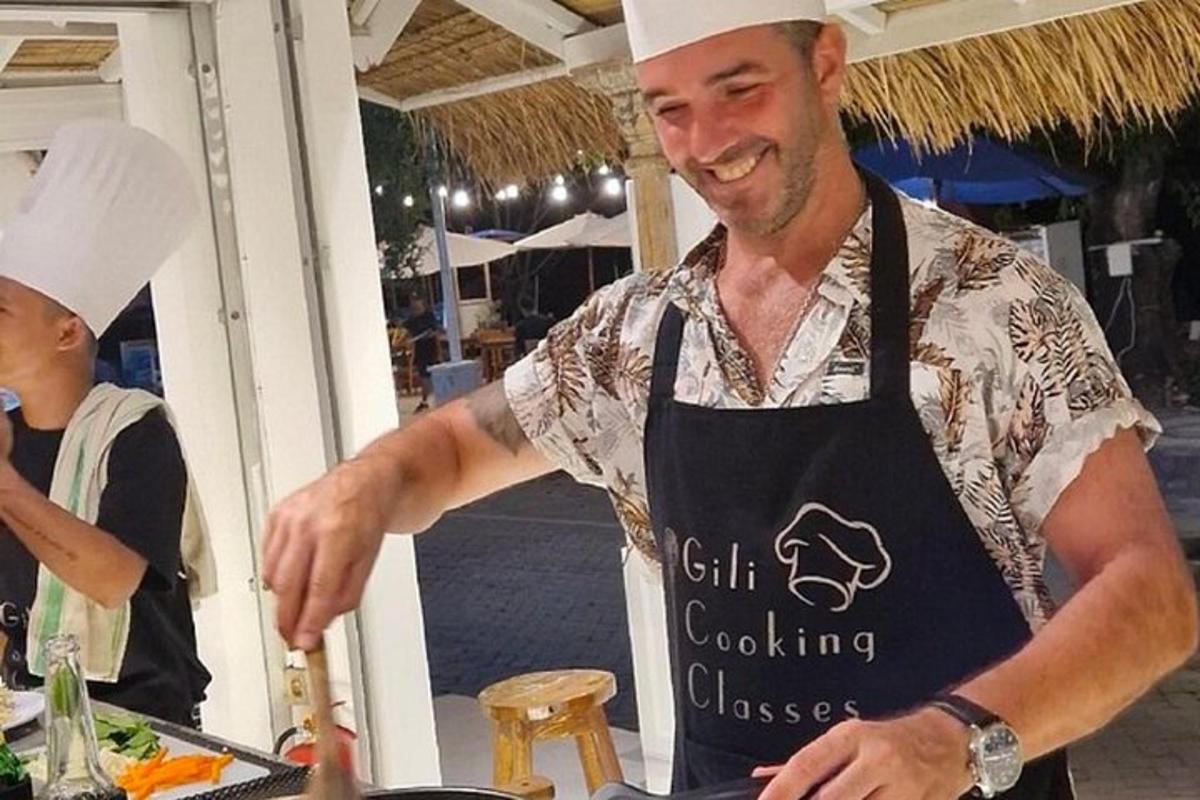 a man in an apron preparing food on a table