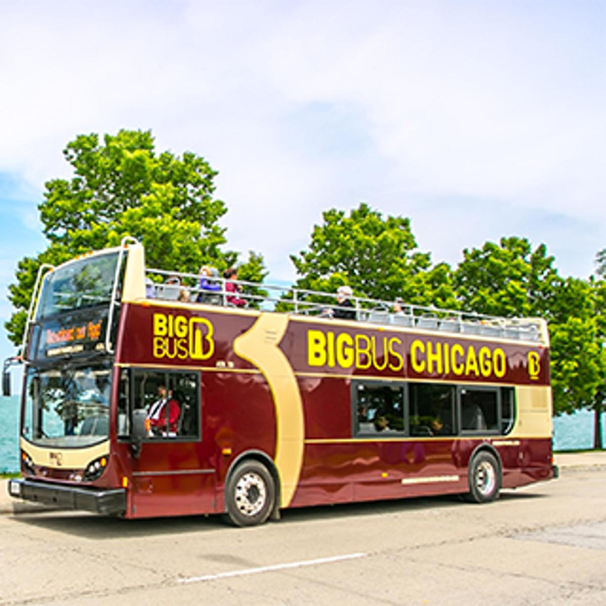a red double decker bus with people on the top