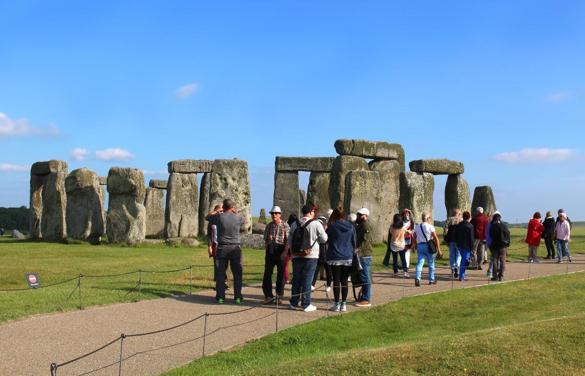 a group of people standing in front of stonehenge