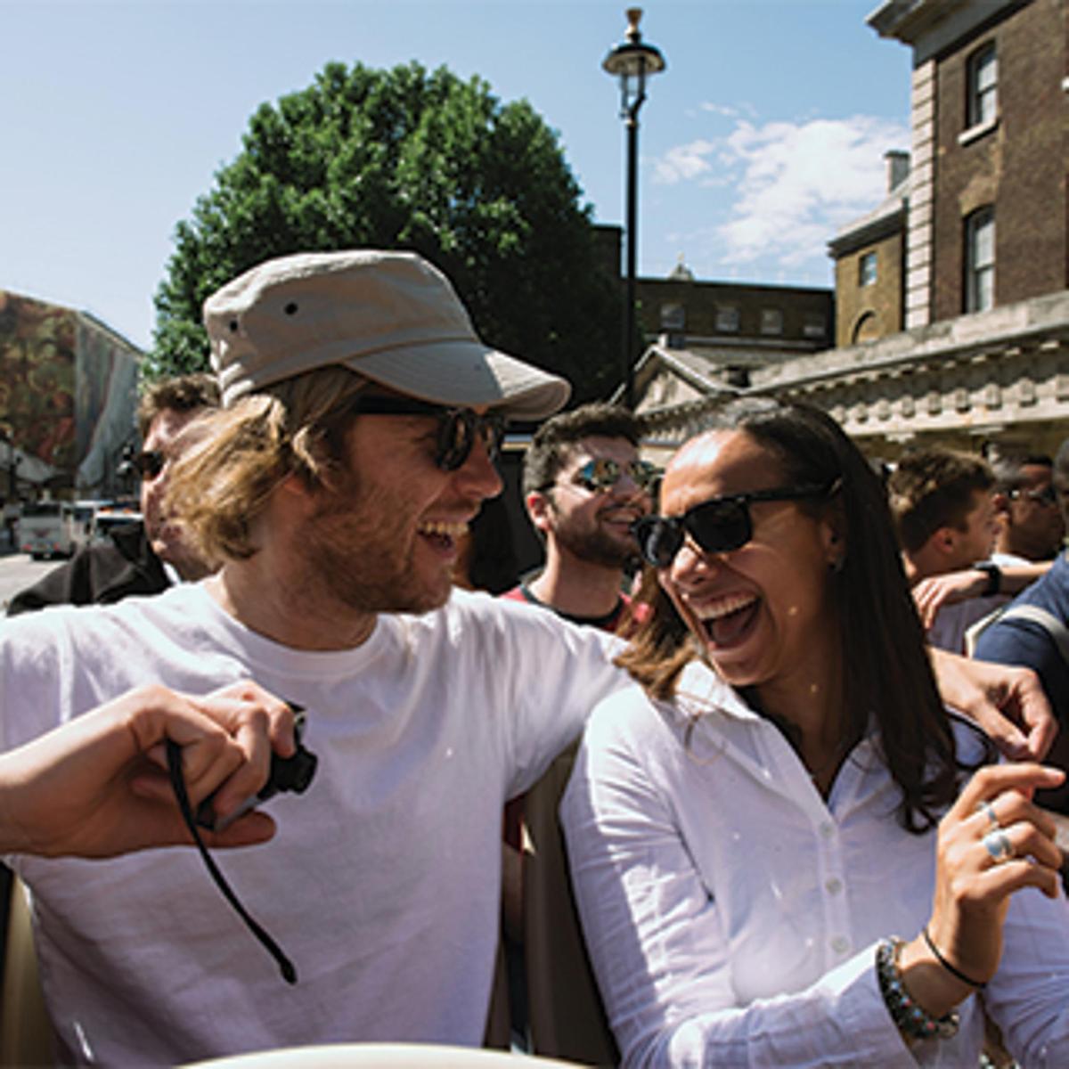a man and a woman smiling in a crowd of people
